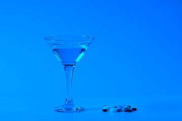 Summer coctail. Pills and glass of water.