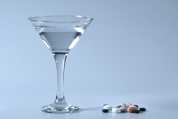 Summer coctail. Pills and glass of water.