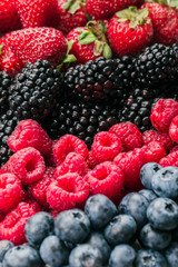 Fresh Summer Berries mix Background with Strawberry, Raspberry, Red currant, Blueberry and Blackberry.