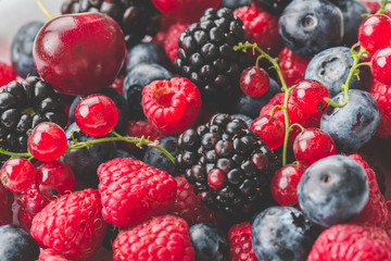 Fresh Summer Berries mix Background with Strawberry, Raspberry, Red currant, Blueberry and Blackberry.