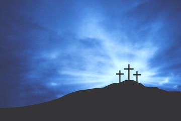 Three Christian Easter Crosses on Hill of Calvary with Blue Clouds in Sky and Copy Space -...