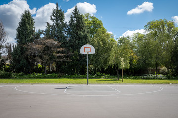 Outdoor basketball court with net removed from backboard due to Covid 19 pandemic © Mary Lynn Strand