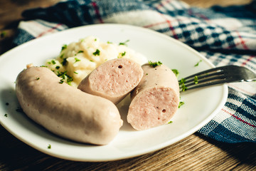 mashed potatoes with sausage on a white plate