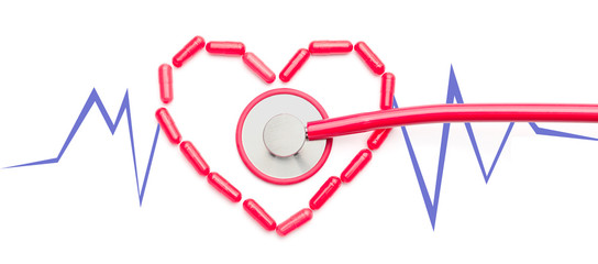 Heart made of pills with drawn cardiogram and stethoscope on white background