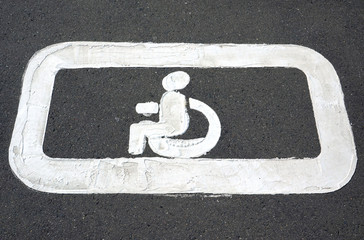 Parking markings for disabled people in a parking lot for cars.