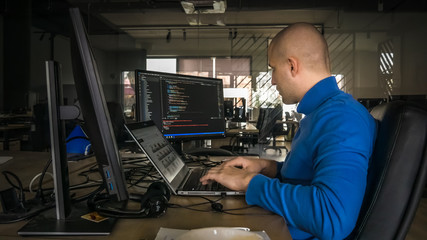 The programmer girl works at the computer