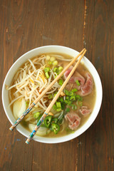 Ramen soup with noodle with meat, fresh herbs and vegetables