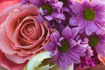  Colourful spiral bouquet of large pink rose, white amaryllis, coral gerbera,ears of wheat,purple carnation and chrysanthemum in the craft paper close up
