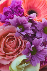  Colourful spiral bouquet of large pink rose, white amaryllis, coral gerbera,ears of wheat,purple carnation and chrysanthemum in the craft paper