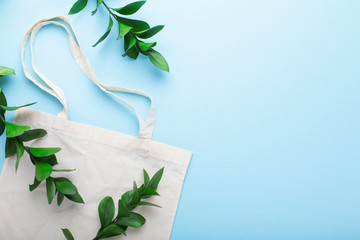 Save the earth. Cotton bag and green leaves
