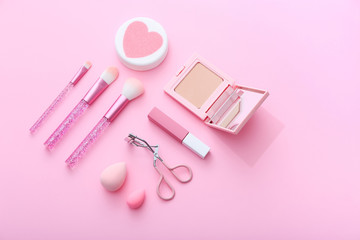 Products for decorative makeup on pastel pink background