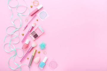 Makeup products on pink background. Top view