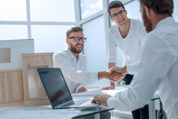 business people shaking hands in the architectural office