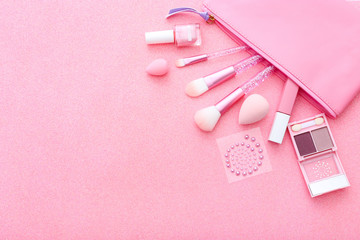 Set of professional decorative cosmetics, makeup tools and accessories on pink sparkle background. Beauty, fashion and concept. Flat lay composition, top view
