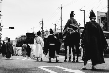 People with traditional costumes of Heian period at Aoi Matsuri parade, Kyoto, Japan (in black and...