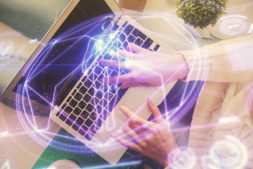 Double exposure of woman hands working on computer and education theme hologram drawing. Top View. Science concept.