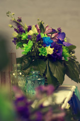 Wedding composition of orchid, chrysanthemum, eustoma on the table