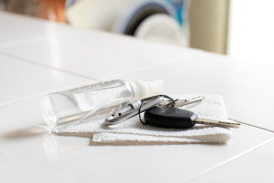 Keys And Spray Bottle With Disinfectant On White Background