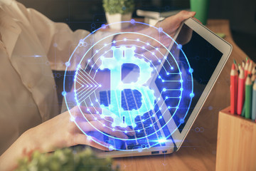 Double exposure of woman hands typing on computer and crypto market theme hologram drawing....