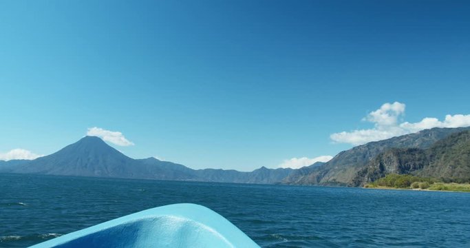 Traveling by Boat across Lake Atitlan with San Pedro and Toliman in the distance