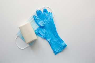 Pair of latex medical gloves, medical masks, sanitizer gel for hand hygiene, remedies, soap, disinfector. Coronavirus prevention white background