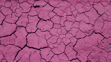 cracked clay texture. beautiful pattern of cracks in a pink clay wall. dried clay.