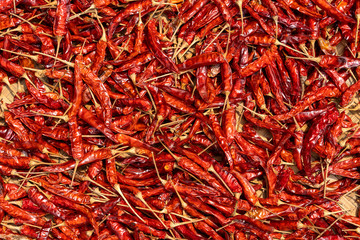 Naklejka premium Red dry hot chili peppers for sale at street food market in Vietnam. Close up