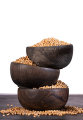 Organic yellow mustard seeds in wooden bowls - Sinapis alba