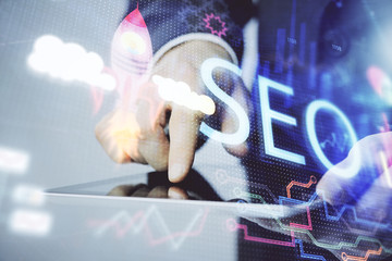 Multi exposure of man's hands holding and using a digital device and seo drawing. search...