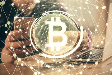 Double exposure of man's hands holding and using a phone and crypto currency blockchain theme drawing.