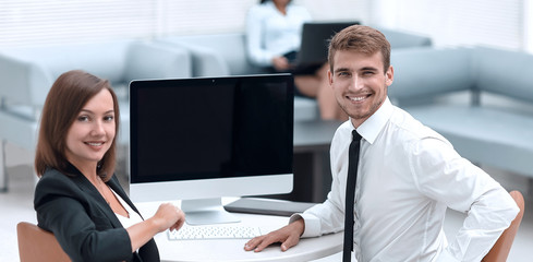 smiling member of the business team sitting at Desk