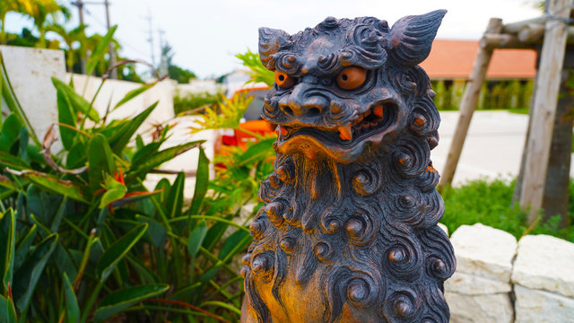 clay traditional japanese mythical shisa statue at sunset Okinawa Japan