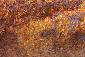 Heavily rusted and corroded metal sheet in an industrial area, suitable as a background, pattern and backdrop
