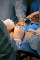 Surgical operation in the hospital. Patient assisted by a doctor. Rubber gloves and medical instruments.