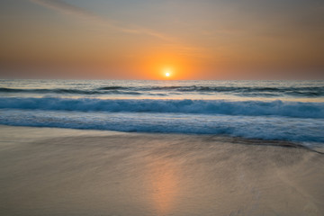 Fototapeta na wymiar Soft Sunrise Seascape with some light cloud