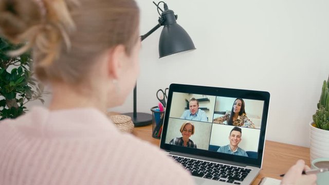 Online Work Team Meeting or Family Call in Group Video Conference on Laptop in Home Office. Happy People Talk and Smile to Collegues via Internet. Self-isolation at Pandemic. 4K Close Up Orbit Shot