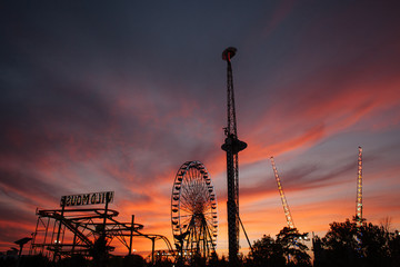 Amusement park on the background of the sunset sky