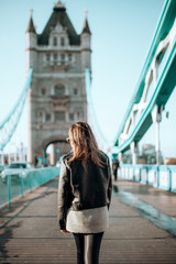 Girl walking on tower bridge on a beautiful blue sky day
