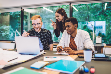Cheerful multiethnic students having fun while studying
