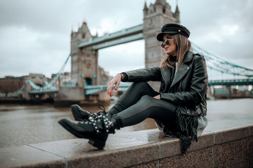 Girl walking on tower bridge on a beautiful blue sky day