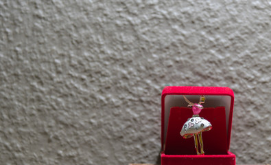 Ballerina brooch on concrete background