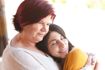 Positive, happy, loving senior mother and daughter embracing