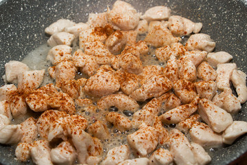 Slices of fried chicken in a pan. Cooking process close up.