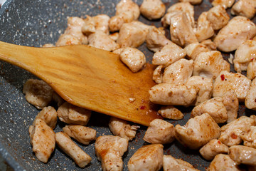 Slices of fried chicken in a pan. Cooking process close up.