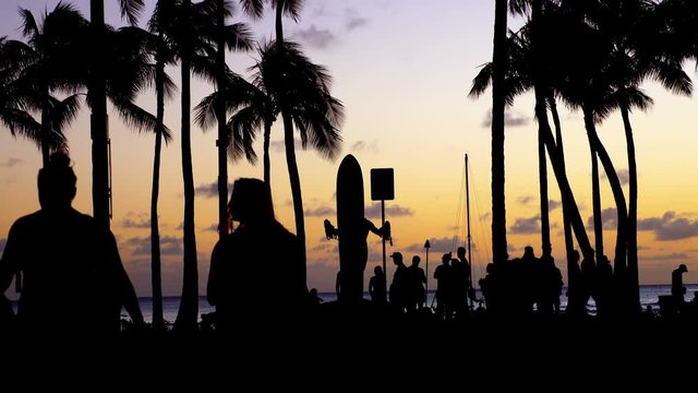 Tourists walking at sunset in Waikiki beach Hawaii in 4k
