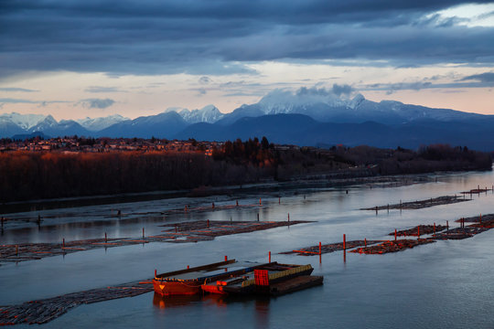 Beautiful Aerial View of Fraser River during a colorful sunset. Taken from Port Mann Bridge, Vancouver, British Columbia, Canada.