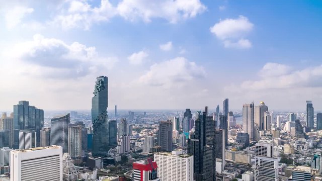 Bangkok business district city center above Silom area, with cloud pass over buildings and skyscrapers; zoom out – Time Lapse