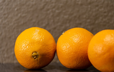 Bay orange or navel (Citrus sinensis) on mirrored surface and neutral background