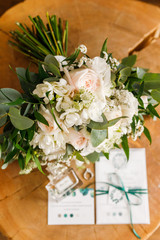 Wedding details. envelope, invitation, wedding rings and a bouquet of flowers