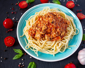 spaghetti bolognese on black background